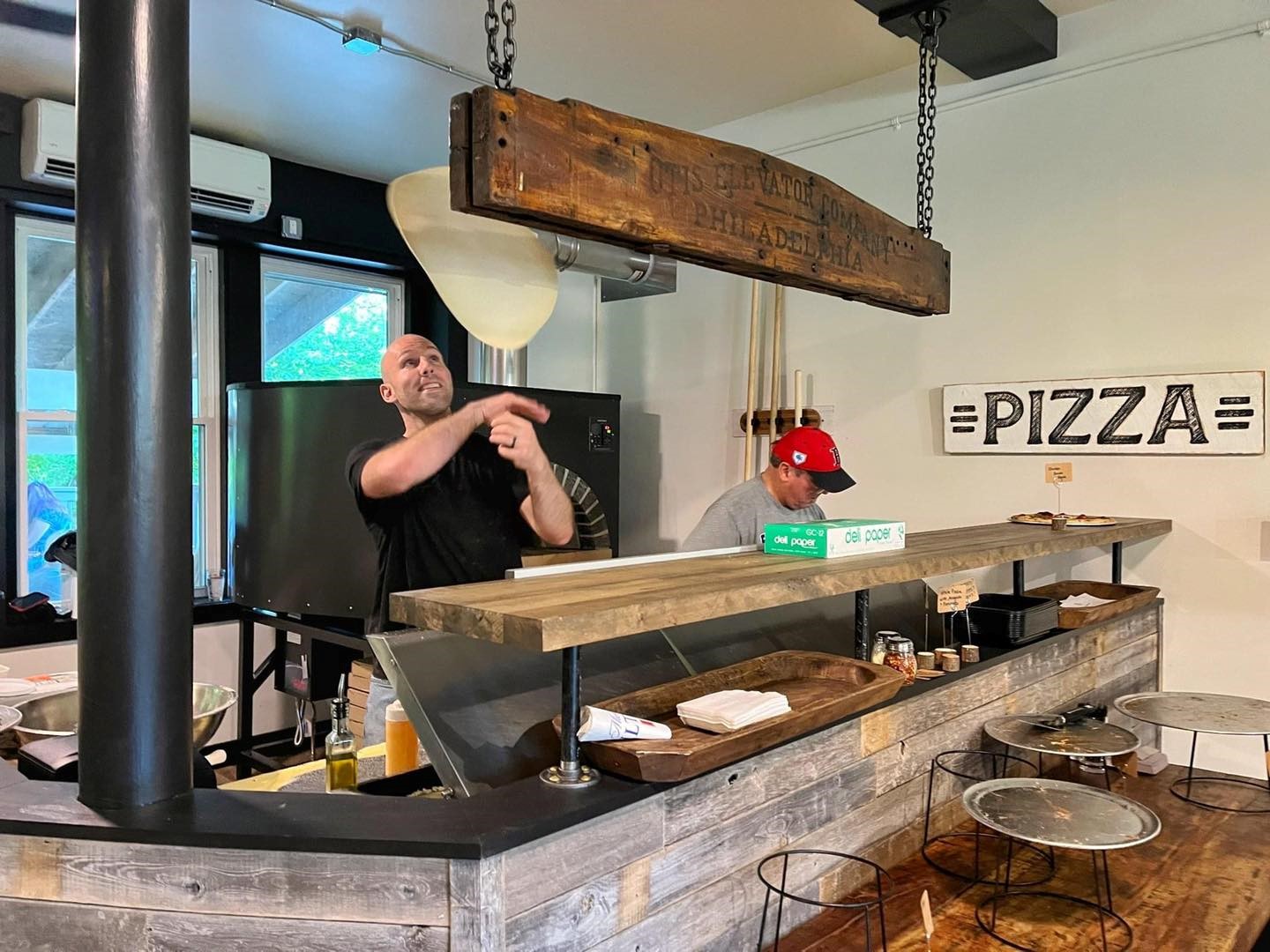 Image of employee tossing pizza